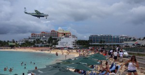 A small commuter/cargo plane lands over the beach on to Runway 10 at Princess Juliana Airport on Sint Maarten