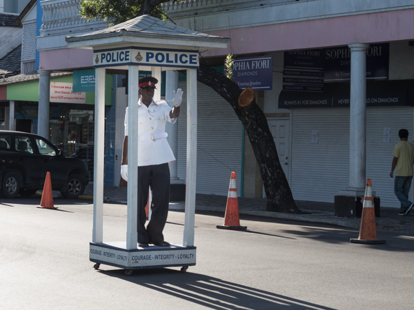 A Bahamian police officer helps traffic along during rush our in Nassau