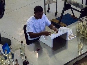 Labels being applied by hand to individual bottles of rum at the John Watling's Distillery on Nassau