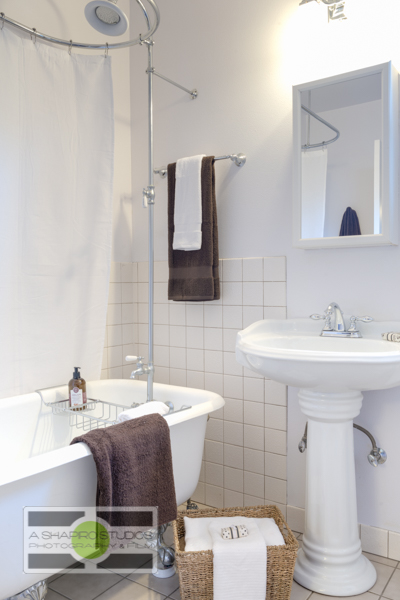 The bathroom, featuring a claw-foot tub, of a Ballard updated Craftsman house.  Seattle Real Estate Photography ©2015 Ari Shapiro - AShapiroStudios.com