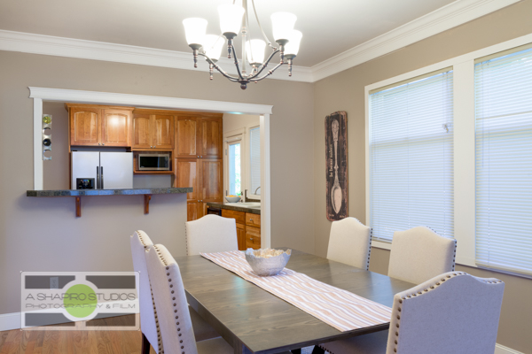 An open-concept dining room leading to the kitchen of a Ballard updated Craftsman house.  Seattle Real Estate Photography ©2015 Ari Shapiro - AShapiroStudios.com