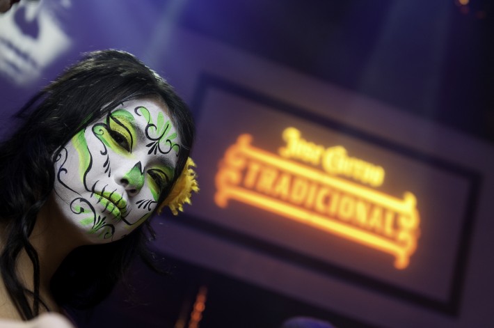A model poses in front of a logo at a Jose Cuervo Subterraneo in Seattle, WA. ©2013 Ari Shapiro - AShapiroStudios.com