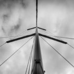 The mast stands tall on this 38' Defour with ominous skies and a halyard slapping against the pole. Fine Art Metallic Print from AShapiro Studios